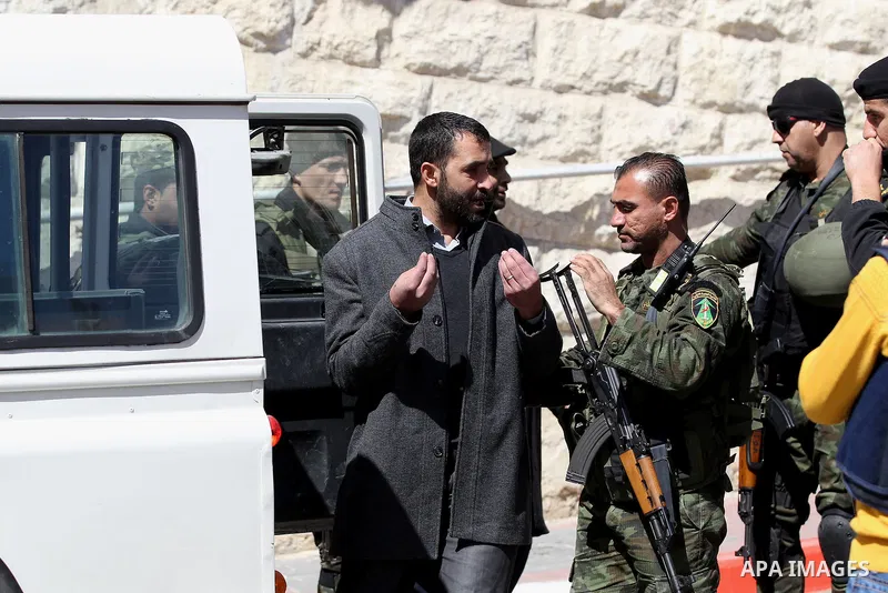 Palestinian security forces detain a demonstrator during a protest organised by Hizb-ut Tahrir against what organisers say are political arrests by the Palestinian Authority in the West Bank city of Hebron February 25, 2...