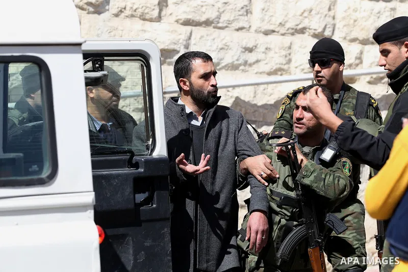 Palestinian security forces detain a demonstrator during a protest organised by Hizb-ut Tahrir against what organisers say are political arrests by the Palestinian Authority in the West Bank city of Hebron February 25, 2...