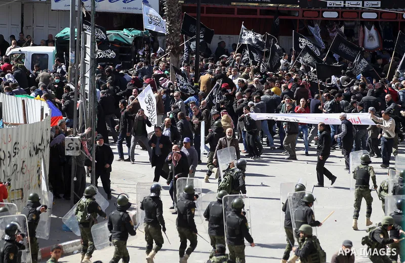 Members of the Palestinian security forces clash with demonstrators during a protest organised by Hizb-ut Tahrir against what organisers say are political arrests by the Palestinian Authority in the West Bank city of Heb...