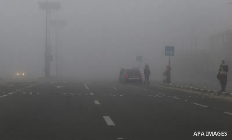 Palestinians walk at a street during foggy morning in Gaza city, on February 26, 2017. Photo by Yasser Qudih
