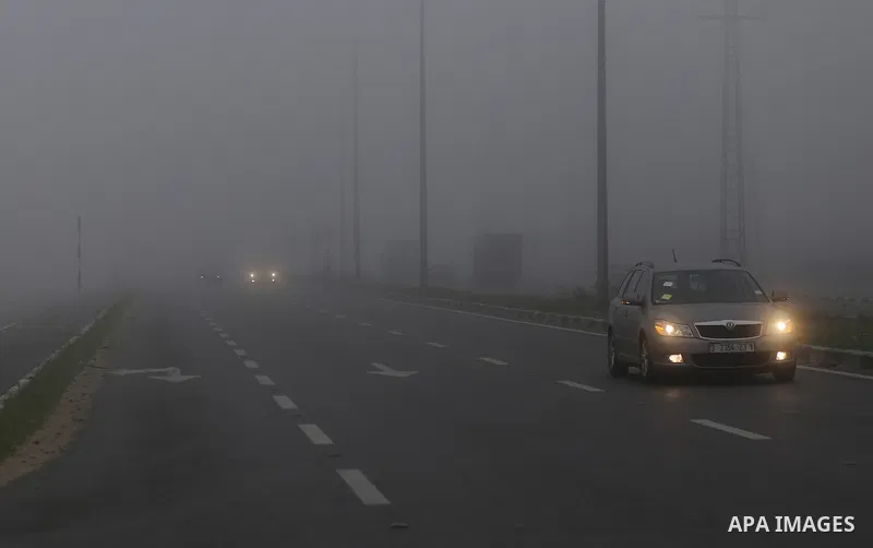 Palestinians ride cars at a street during foggy morning in Gaza city, on February 26, 2017. Photo by Yasser Qudih