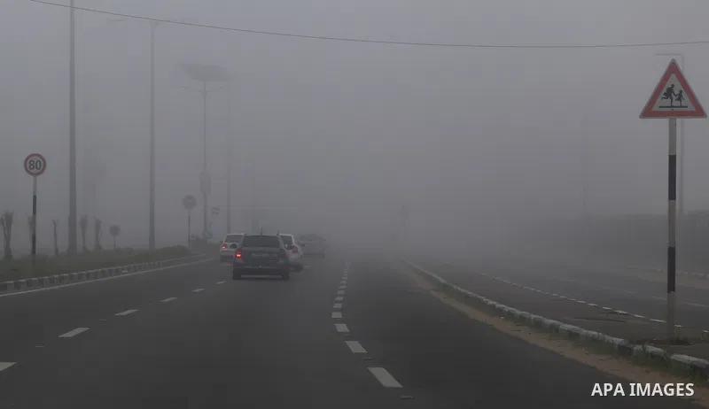 Palestinians ride cars at a street during foggy morning in Gaza city, on February 26, 2017. Photo by Yasser Qudih