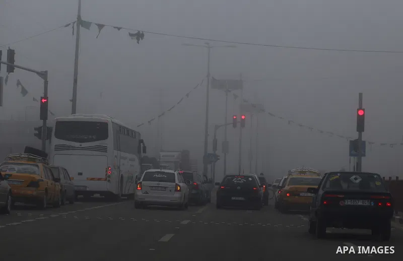 Palestinians ride cars at a street during foggy morning in Gaza city, on February 26, 2017. Photo by Yasser Qudih