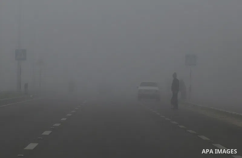 Palestinians walk at a street during foggy morning in Gaza city, on February 26, 2017. Photo by Yasser Qudih