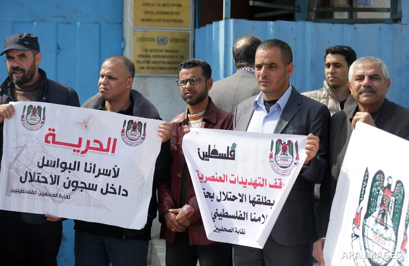 Palestinians hold placards during a protest to show solidarity with Palestinian prisoners held in Israeli Jails, in Gaza city, on February 26, 2017. Photo by Ashraf Amra