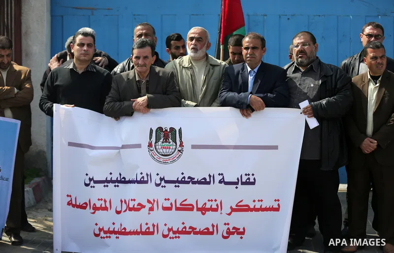Palestinians hold placards during a protest to show solidarity with Palestinian prisoners held in Israeli Jails, in Gaza city, on February 26, 2017. Photo by Ashraf Amra