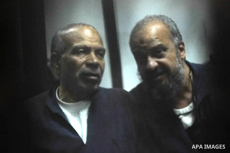 Defendants of Egyptian Muslim Brotherhood sit behind the defendants cage as they attend their trial along with Egyptian ousted president Mohammed Morsi (unseen), on the outskirts of the capital Cairo, on February 26, 201...