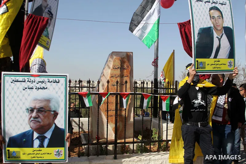 Masked Palestinians holds the pictures of Palestinian teenager Qusai Al-Amour, a 17-year-old who was shot dead, during a demonstration in the West Bank village of Tuqua, near Bethlehem, 26 February 2017. Emoor, a member...