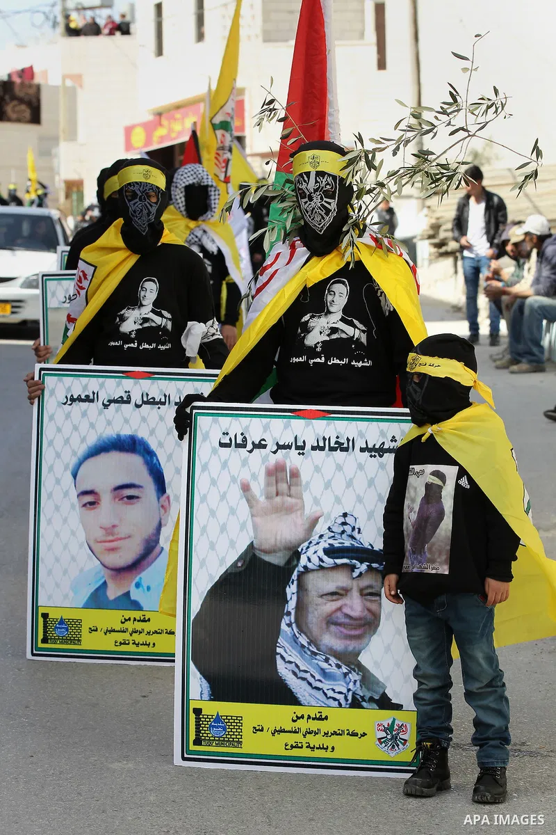 Masked Palestinians holds the pictures of Palestinian teenager Qusai Al-Amour, a 17-year-old who was shot dead, during a demonstration in the West Bank village of Tuqua, near Bethlehem, 26 February 2017. Emoor, a member...