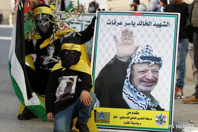 Masked Palestinians holds the pictures of Palestinian teenager Qusai Al-Amour, a 17-year-old who was shot dead, during a demonstration in the West Bank village of Tuqua, near Bethlehem, 26 February 2017. Emoor, a member...