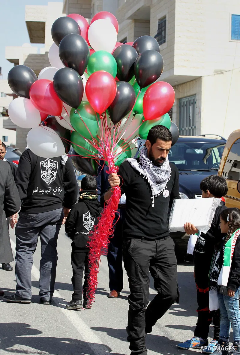 Masked Palestinians holds the pictures of Palestinian teenager Qusai Al-Amour, a 17-year-old who was shot dead, during a demonstration in the West Bank village of Tuqua, near Bethlehem, 26 February 2017. Emoor, a member...