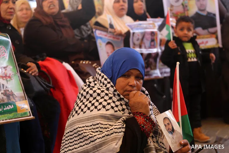 Palestinians hold placards during a protest to show solidarity with Palestinian prisoners held in Israeli Jails, in front of Red cross office in Gaza city, on February 27, 2017. Photo by Mohammed Asad
