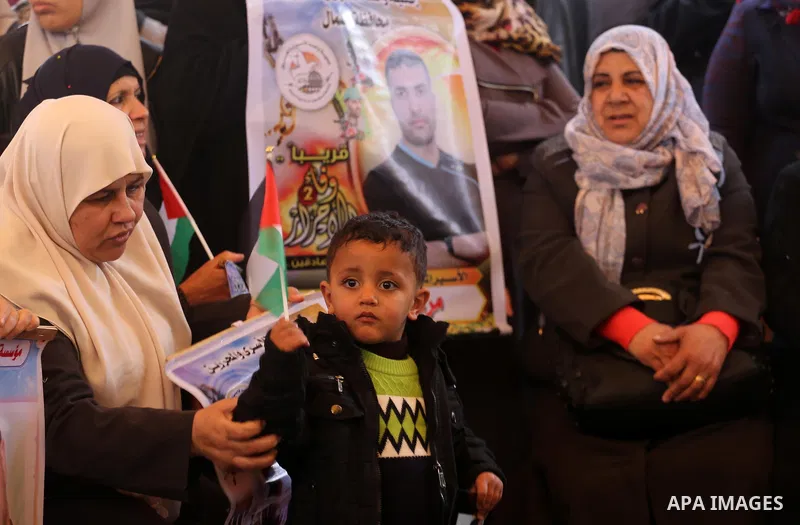 Palestinians hold placards during a protest to show solidarity with Palestinian prisoners held in Israeli Jails, in front of Red cross office in Gaza city, on February 27, 2017. Photo by Mohammed Asad