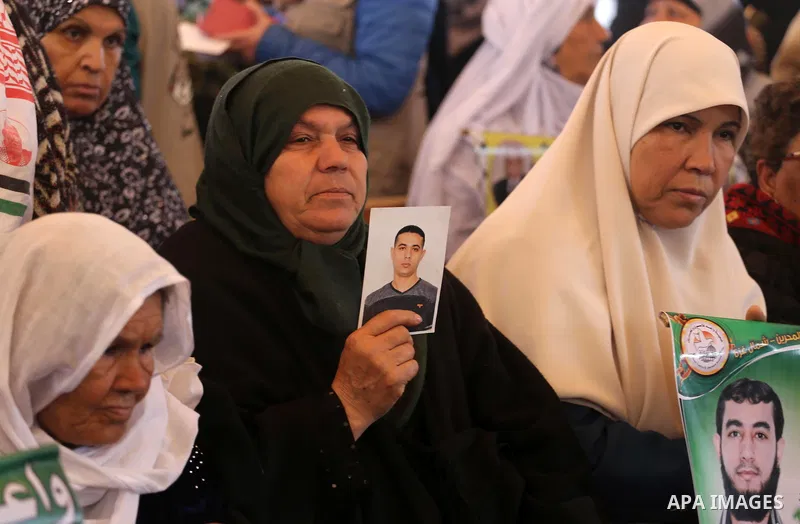 Palestinians hold placards during a protest to show solidarity with Palestinian prisoners held in Israeli Jails, in front of Red cross office in Gaza city, on February 27, 2017. Photo by Mohammed Asad
