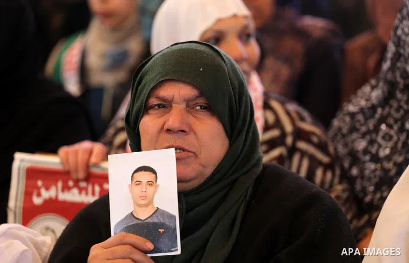 Palestinians hold placards during a protest to show solidarity with Palestinian prisoners held in Israeli Jails, in front of Red cross office in Gaza city, on February 27, 2017. Photo by Mohammed Asad