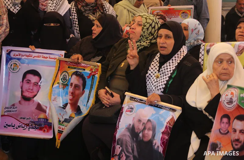Palestinians hold placards during a protest to show solidarity with Palestinian prisoners held in Israeli Jails, in front of Red cross office in Gaza city, on February 27, 2017. Photo by Mohammed Asad