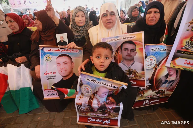 Palestinians hold placards during a protest to show solidarity with Palestinian prisoners held in Israeli Jails, in front of Red cross office in Gaza city, on February 27, 2017. Photo by Mohammed Asad