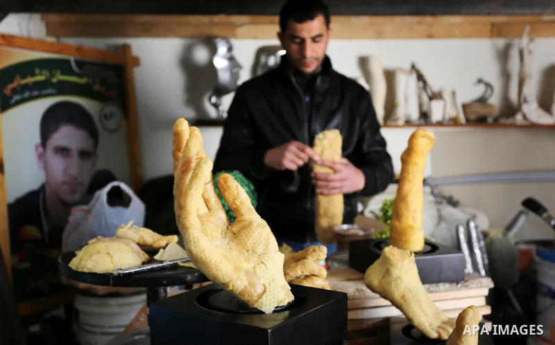 Palestinian artist, Mohammed Abu Hashish, 29, uses beeswax to produce models of human limb, at his workshop, in the al-Maghazi refugee camp, in the centre of the Gaza Strip, on February 27, 2017. Photo by Ashraf Amra