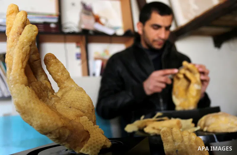 Palestinian artist, Mohammed Abu Hashish, 29, uses beeswax to produce models of human limb, at his workshop, in the al-Maghazi refugee camp, in the centre of the Gaza Strip, on February 27, 2017. Photo by Ashraf Amra