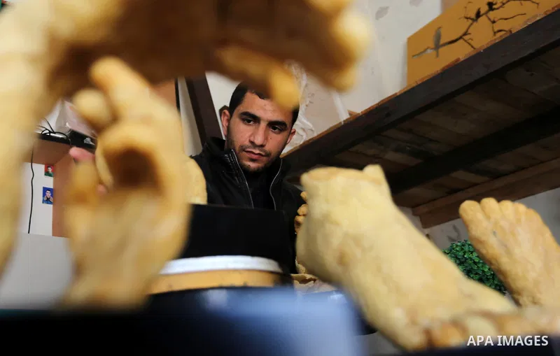 Palestinian artist, Mohammed Abu Hashish, 29, uses beeswax to produce models of human limb, at his workshop, in the al-Maghazi refugee camp, in the centre of the Gaza Strip, on February 27, 2017. Photo by Ashraf Amra