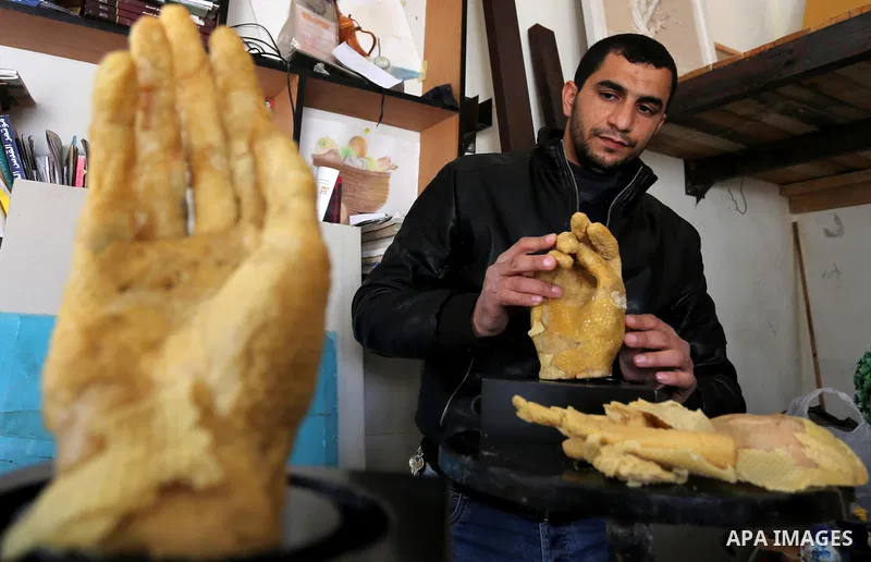 Palestinian artist, Mohammed Abu Hashish, 29, uses beeswax to produce models of human limb, at his workshop, in the al-Maghazi refugee camp, in the centre of the Gaza Strip, on February 27, 2017. Photo by Ashraf Amra