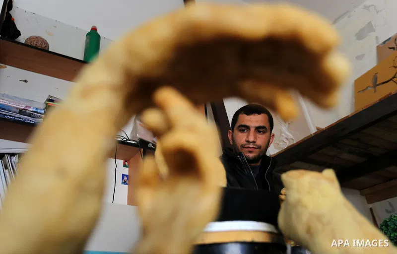 Palestinian artist, Mohammed Abu Hashish, 29, uses beeswax to produce models of human limb, at his workshop, in the al-Maghazi refugee camp, in the centre of the Gaza Strip, on February 27, 2017. Photo by Ashraf Amra