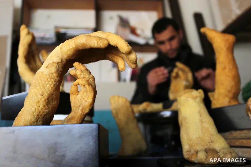 Palestinian artist, Mohammed Abu Hashish, 29, uses beeswax to produce models of human limb, at his workshop, in the al-Maghazi refugee camp, in the centre of the Gaza Strip, on February 27, 2017. Photo by Ashraf Amra