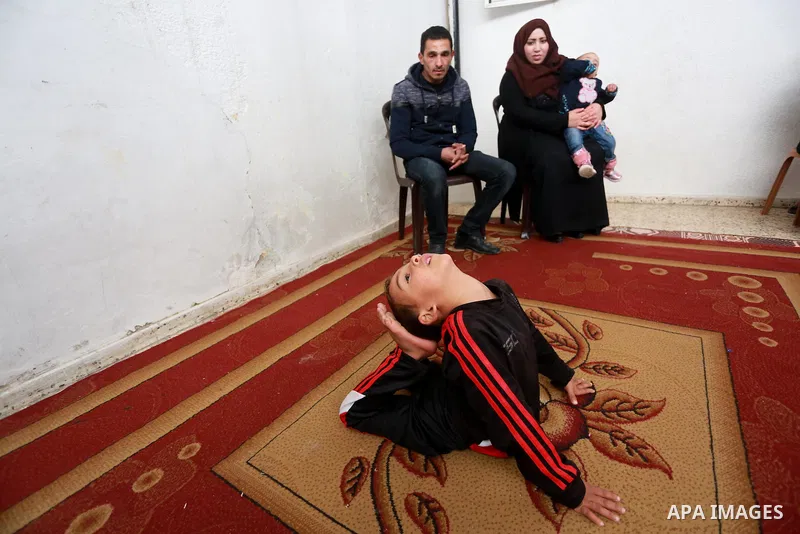 Wael Gharbaoui, a 6-year-old Palestinian boy, demonstrates acrobatics skills at his house in Jabalia refugee camp in the northern Gaza Strip, on March 01, 2017. Photo by Mohammed Asad