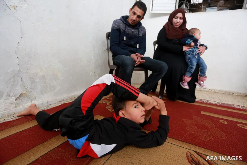 Wael Gharbaoui, a 6-year-old Palestinian boy, demonstrates acrobatics skills at his house in Jabalia refugee camp in the northern Gaza Strip, on March 01, 2017. Photo by Mohammed Asad