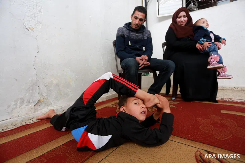 Wael Gharbaoui, a 6-year-old Palestinian boy, demonstrates acrobatics skills at his house in Jabalia refugee camp in the northern Gaza Strip, on March 01, 2017. Photo by Mohammed Asad