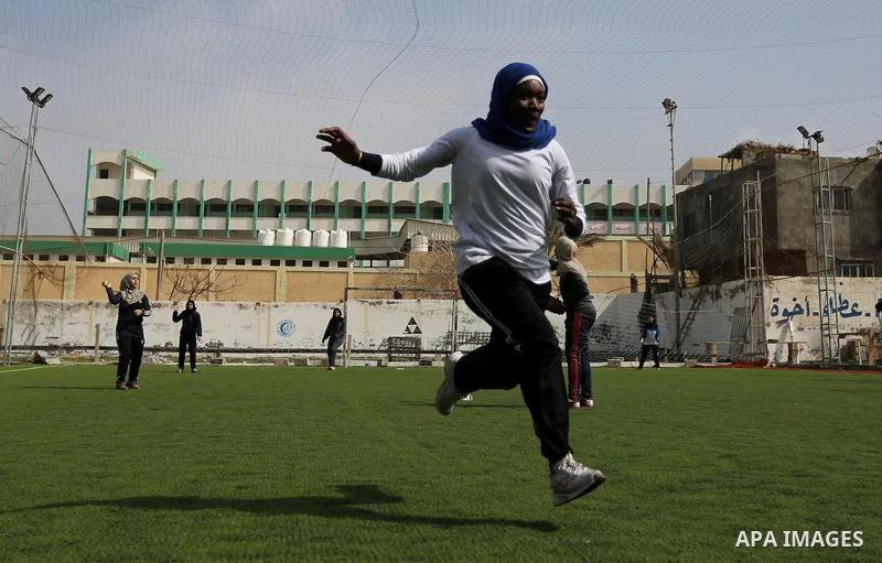 A Palestinian girl takes part in Baseball training, in Gaza city, on February 20, 2017. Baseball is a bat-and-ball game played between two teams of nine players each, who take turns batting and fielding. Baseball is thou...