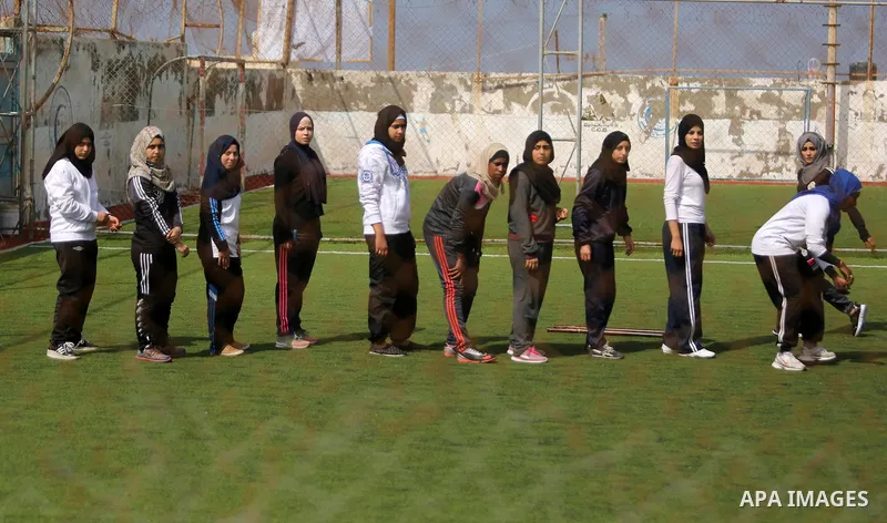 A Palestinian girl takes part in Baseball training, in Gaza city, on February 20, 2017. Baseball is a bat-and-ball game played between two teams of nine players each, who take turns batting and fielding. Baseball is thou...