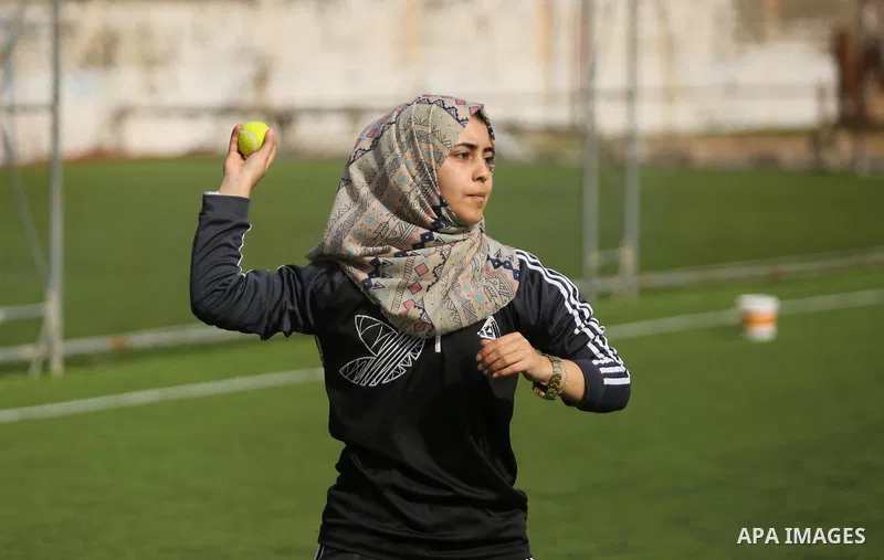 A Palestinian girl takes part in Baseball training, in Gaza city, on February 20, 2017. Baseball is a bat-and-ball game played between two teams of nine players each, who take turns batting and fielding. Baseball is thou...