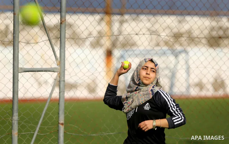 A Palestinian girl takes part in Baseball training, in Gaza city, on February 20, 2017. Baseball is a bat-and-ball game played between two teams of nine players each, who take turns batting and fielding. Baseball is thou...