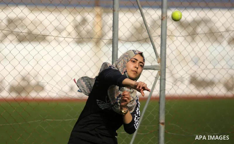 A Palestinian girl takes part in Baseball training, in Gaza city, on February 20, 2017. Baseball is a bat-and-ball game played between two teams of nine players each, who take turns batting and fielding. Baseball is thou...