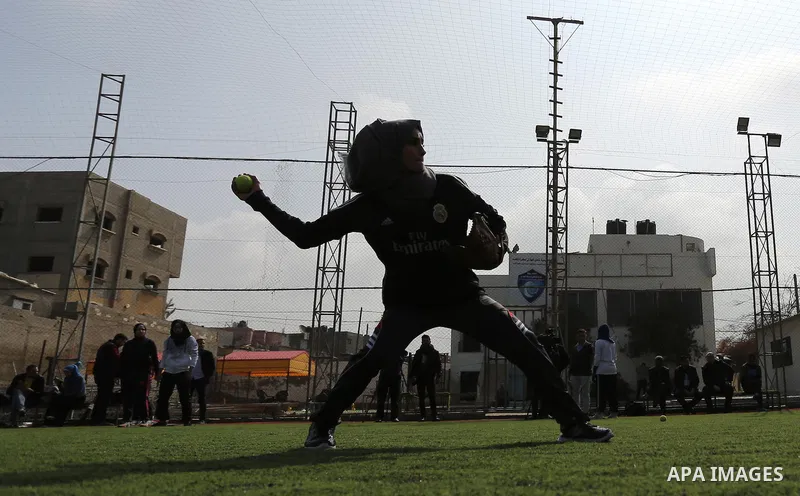 A Palestinian girl takes part in Baseball training, in Gaza city, on February 20, 2017. Baseball is a bat-and-ball game played between two teams of nine players each, who take turns batting and fielding. Baseball is thou...