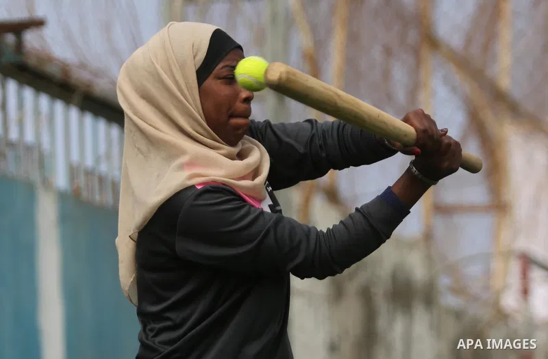 A Palestinian girl takes part in Baseball training, in Gaza city, on February 20, 2017. Baseball is a bat-and-ball game played between two teams of nine players each, who take turns batting and fielding. Baseball is thou...
