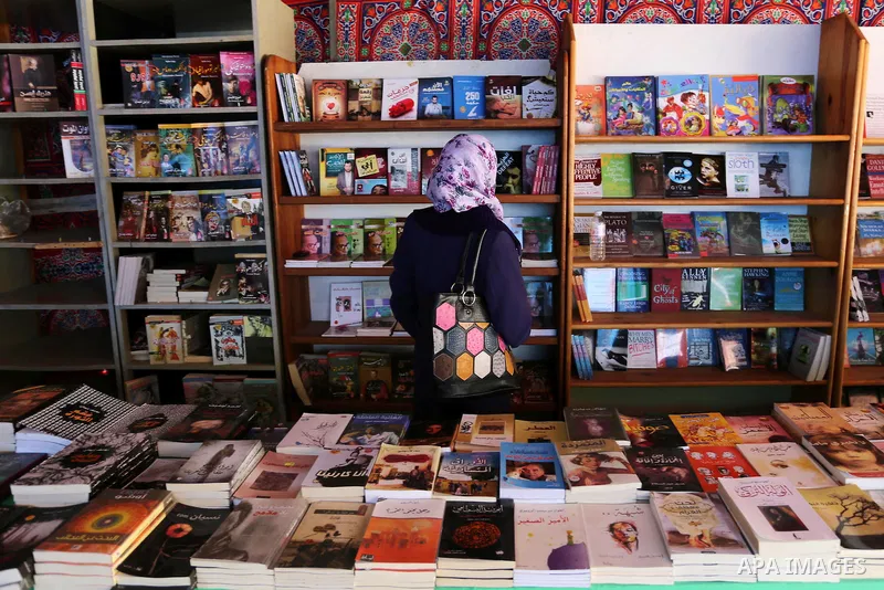 Palestinians browse through books on a stand at a book fair, in Gaza city on March 04, 2017. Photo by Ashraf Amra