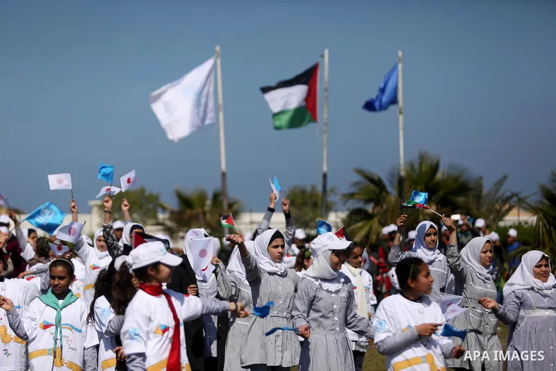Palestinian schoolgirls fly kites to show solidarity with the Japanese people during an event organised by the United Nations Relief and Works Agency (UNRWA) to mark the the sixth anniversary of the Tohoku earthquake and...