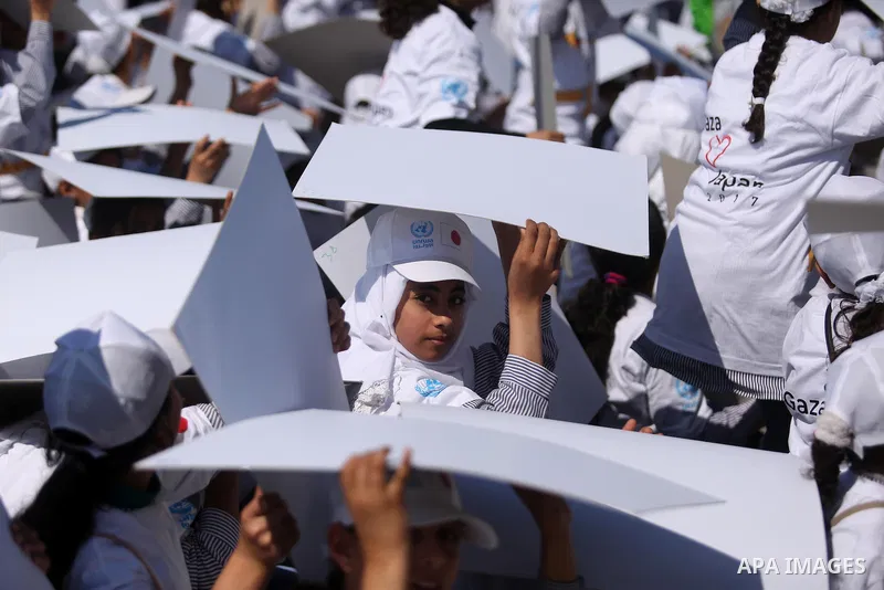 Palestinian schoolgirls fly kites to show solidarity with the Japanese people during an event organised by the United Nations Relief and Works Agency (UNRWA) to mark the the sixth anniversary of the Tohoku earthquake and...