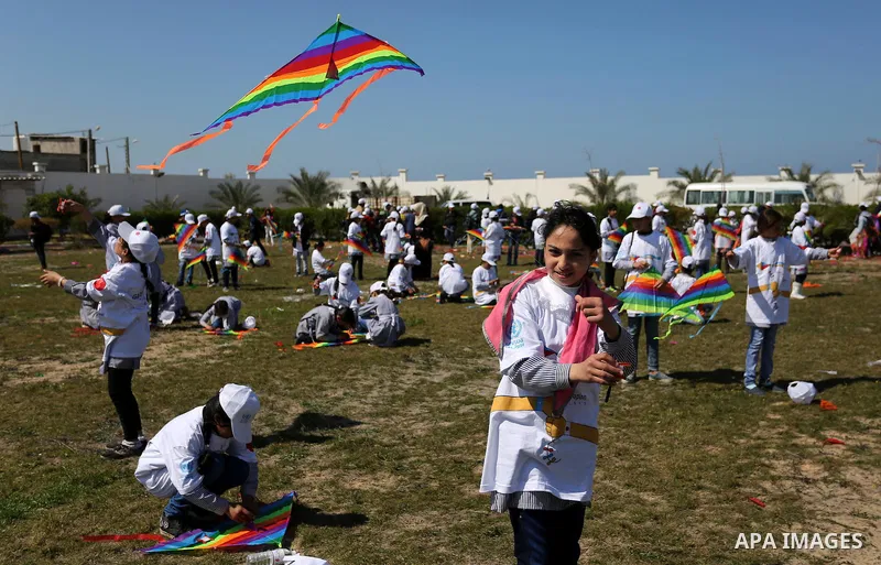 Palestinian schoolgirls fly kites to show solidarity with the Japanese people during an event organised by the United Nations Relief and Works Agency (UNRWA) to mark the the sixth anniversary of the Tohoku earthquake and...