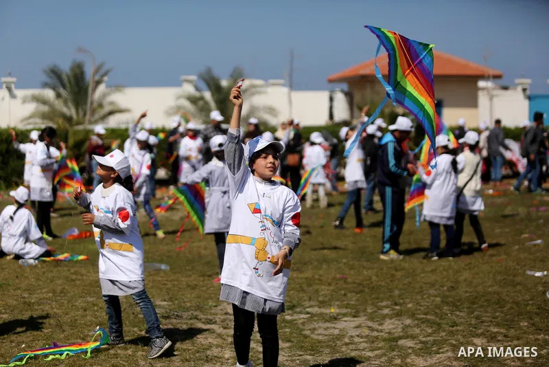 Palestinian schoolgirls fly kites to show solidarity with the Japanese people during an event organised by the United Nations Relief and Works Agency (UNRWA) to mark the the sixth anniversary of the Tohoku earthquake and...
