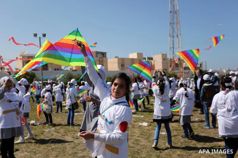 Palestinian schoolgirls fly kites to show solidarity with the Japanese people during an event organised by the United Nations Relief and Works Agency (UNRWA) to mark the the sixth anniversary of the Tohoku earthquake and...