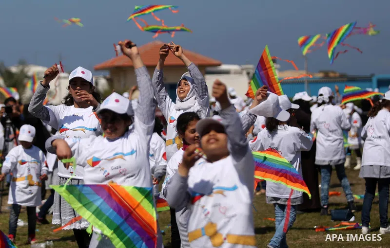 Palestinian schoolgirls fly kites to show solidarity with the Japanese people during an event organised by the United Nations Relief and Works Agency (UNRWA) to mark the the sixth anniversary of the Tohoku earthquake and...