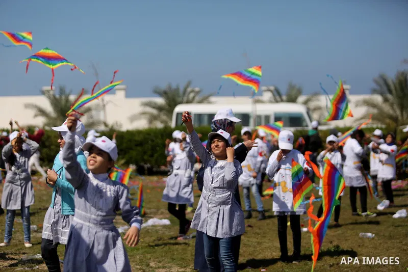 Palestinian schoolgirls fly kites to show solidarity with the Japanese people during an event organised by the United Nations Relief and Works Agency (UNRWA) to mark the the sixth anniversary of the Tohoku earthquake and...