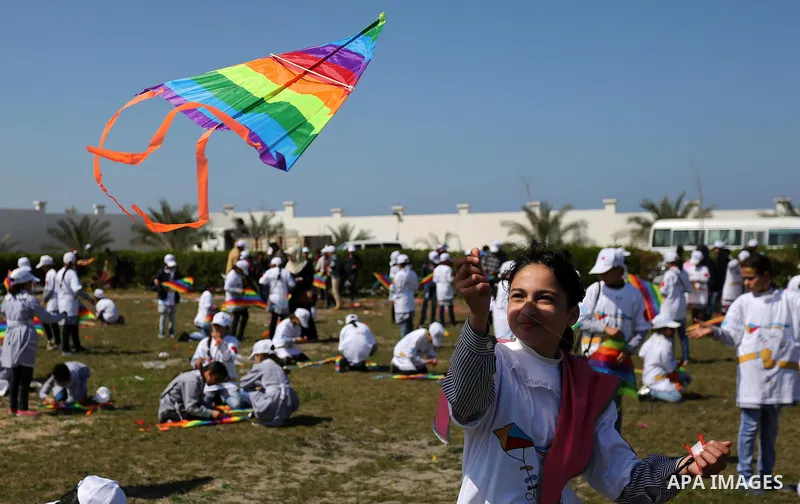 Palestinian schoolgirls fly kites to show solidarity with the Japanese people during an event organised by the United Nations Relief and Works Agency (UNRWA) to mark the the sixth anniversary of the Tohoku earthquake and...