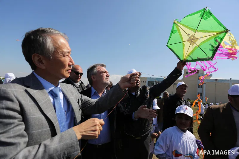 Bo Schack, director of United Nations Relief and Works Agency operations in Gaza, and Japanese ambassador Takeshi Okubo fly kites during an event organised by the United Nations Relief and Works Agency (UNRWA) to mark th...