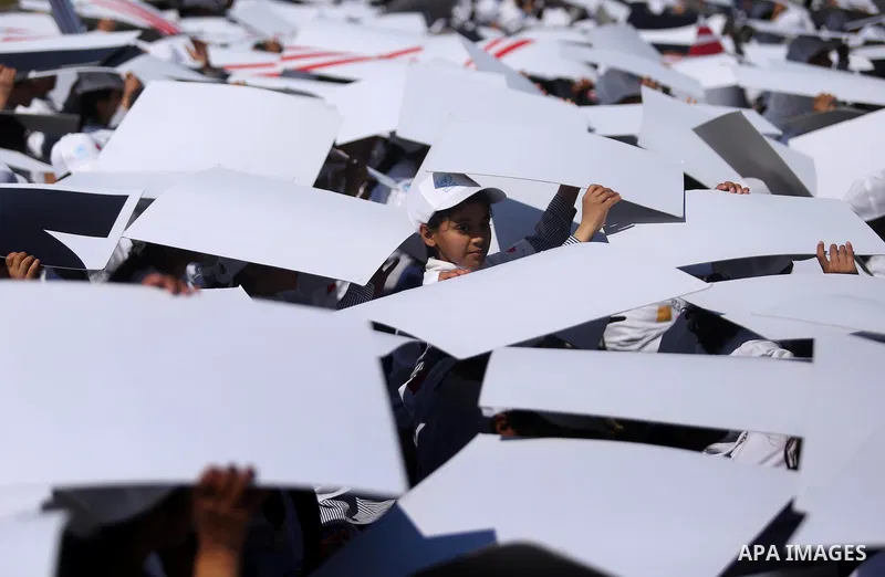 Palestinian schoolgirls fly kites to show solidarity with the Japanese people during an event organised by the United Nations Relief and Works Agency (UNRWA) to mark the the sixth anniversary of the Tohoku earthquake and...