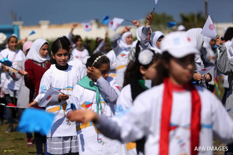 Palestinian schoolgirls fly kites to show solidarity with the Japanese people during an event organised by the United Nations Relief and Works Agency (UNRWA) to mark the the sixth anniversary of the Tohoku earthquake and...