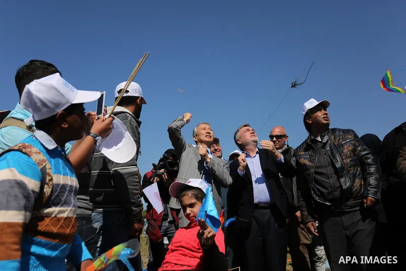 Bo Schack, director of United Nations Relief and Works Agency operations in Gaza, and Japanese ambassador Takeshi Okubo fly kites during an event organised by the United Nations Relief and Works Agency (UNRWA) to mark th...
